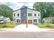 Modern duplex with striking two-tone exterior, fresh landscaping, and stylish garage doors at 2733 Cowles Rd, Charlotte, NC 28208