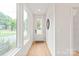 Bright foyer with wood floors, large windows, and a modern door, creating an open and inviting space at 2733 Cowles Rd, Charlotte, NC 28208