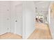 Clean hallway featuring wood floors and white walls, leading to a spacious dining and living area at 2733 Cowles Rd, Charlotte, NC 28208