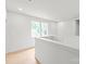 Bright hallway with wood floors, white walls, and natural light from large windows at 2733 Cowles Rd, Charlotte, NC 28208