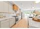 Bright kitchen featuring stainless steel appliances, white cabinetry, quartz countertops, and hardwood floors at 2733 Cowles Rd, Charlotte, NC 28208