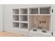 Custom pet station featuring tiled backsplash, bowls, white cabinetry, and hardwood floors at 2733 Cowles Rd, Charlotte, NC 28208