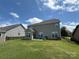 Spacious fenced backyard featuring a well-maintained lawn, small patio, and serene outdoor living space at 2810 Shumard Dr, Gastonia, NC 28054