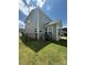Fenced backyard showcasing green grass, the home's gray siding, and space for outdoor activities and leisure at 2810 Shumard Dr, Gastonia, NC 28054
