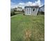 View of the backyard shed offering practical outdoor storage, set in a green, fenced lawn at 2810 Shumard Dr, Gastonia, NC 28054