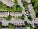 Aerial view of a townhome community featuring mature trees, parking, and lush landscaping at 3414 Broadwick St, Charlotte, NC 28213