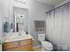 Clean bathroom with a vanity sink, toilet, and shower curtain at 3414 Broadwick St, Charlotte, NC 28213