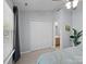 Bedroom featuring a ceiling fan and closet, with a glimpse into the ensuite bathroom at 3414 Broadwick St, Charlotte, NC 28213