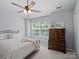 Serene bedroom with a large window, ceiling fan, and classic wooden dresser at 3414 Broadwick St, Charlotte, NC 28213