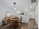 Bright dining area with a wooden table set, stylish lighting, and seamless flow to the kitchen at 3414 Broadwick St, Charlotte, NC 28213