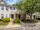 Inviting townhome featuring a brick facade, well-maintained landscaping, and a charming covered entrance at 3414 Broadwick St, Charlotte, NC 28213