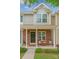 Inviting front porch with brick accents, cozy seating, and manicured landscaping at 3414 Broadwick St, Charlotte, NC 28213