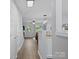 Hallway with wood floors and neutral paint leads to living area at 3414 Broadwick St, Charlotte, NC 28213