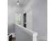 Upper hallway featuring an open bedroom, washer/dryer and closet space at 3414 Broadwick St, Charlotte, NC 28213