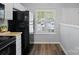 Bright kitchen with white cabinets and black appliances; window view at 3414 Broadwick St, Charlotte, NC 28213