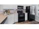 Functional kitchen featuring white cabinets and black appliances at 3414 Broadwick St, Charlotte, NC 28213