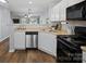 Open kitchen with stainless steel dishwasher and white cabinets, open floor plan at 3414 Broadwick St, Charlotte, NC 28213