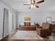 Comfortable living room with leather furniture, a ceiling fan, and sliding doors to the outdoor space at 3414 Broadwick St, Charlotte, NC 28213