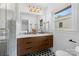 Bright bathroom featuring double vanities with modern fixtures, stylish mirrors, and a glass-enclosed shower at 3701 Table Rock Rd, Charlotte, NC 28226