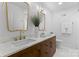 Modern bathroom featuring double vanity, marble countertops, and sleek gold-tone fixtures at 3701 Table Rock Rd, Charlotte, NC 28226