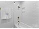 Clean white bathroom with a tub and shower combination with white subway tile at 3701 Table Rock Rd, Charlotte, NC 28226