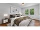 Stylishly staged bedroom with a large window providing ample natural light and green outdoor view at 3701 Table Rock Rd, Charlotte, NC 28226