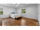 Bright bedroom with hardwood floors, a bed with stylish pillows, and natural light streaming through the windows at 3701 Table Rock Rd, Charlotte, NC 28226
