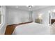 Spacious bedroom with hardwood floors, a large bed, a chest of drawers, and multiple closets for ample storage at 3701 Table Rock Rd, Charlotte, NC 28226