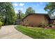A beautiful single-story brick home featuring a well-kept lawn and a curved driveway at 3701 Table Rock Rd, Charlotte, NC 28226