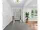 Bright foyer featuring slate floors, modern lighting, and views into the adjoining rooms at 3701 Table Rock Rd, Charlotte, NC 28226