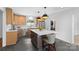 Bright kitchen with a large island, stainless steel appliances, and adjacent laundry room at 3701 Table Rock Rd, Charlotte, NC 28226