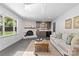 Sun-drenched living room features a fireplace, a skylight, bar area, and backyard views at 3701 Table Rock Rd, Charlotte, NC 28226