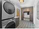 Convenient mudroom with gray cabinets, bench, and modern washer/dryer set at 3701 Table Rock Rd, Charlotte, NC 28226