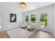 Bright sunroom with two chairs, a table, large windows, modern light fixture, and tile flooring at 3701 Table Rock Rd, Charlotte, NC 28226