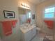 Bright bathroom with a white vanity, framed mirror, and fresh coral towels, creating a clean and inviting space at 4032 Wilgrove Way Dr # 252, Charlotte, NC 28213