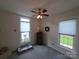 Bright bedroom features two windows, ceiling fan, and a cozy atmosphere with neutral paint and carpet at 4032 Wilgrove Way Dr # 252, Charlotte, NC 28213