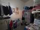 Organized walk-in closet with wire shelving and hanging clothes at 4032 Wilgrove Way Dr # 252, Charlotte, NC 28213