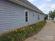 Home exterior showing flower beds with solar lighting down the side of the house at 4032 Wilgrove Way Dr # 252, Charlotte, NC 28213