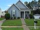 Charming home with manicured lawn, front porch, and a view of the detached garage at 4032 Wilgrove Way Dr # 252, Charlotte, NC 28213