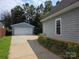 Detached two-car garage with a long driveway and partial view of the home's exterior at 4032 Wilgrove Way Dr # 252, Charlotte, NC 28213