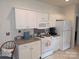 Kitchen featuring white cabinets, appliances, and neutral countertops at 4032 Wilgrove Way Dr # 252, Charlotte, NC 28213