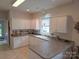 Charming kitchen with white cabinets, neutral countertops and natural light at 4032 Wilgrove Way Dr # 252, Charlotte, NC 28213