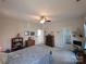 Spacious bedroom with ceiling fan, neutral walls, carpet flooring, and two entry doors at 4032 Wilgrove Way Dr # 252, Charlotte, NC 28213