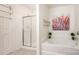Bright bathroom with a separate shower and soaking tub, accentuated by colorful artwork at 4068 Sherri Ln, Fort Mill, SC 29715