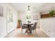 Bright breakfast nook with a round table, upholstered chairs, and natural light streaming in through the window at 4068 Sherri Ln, Fort Mill, SC 29715
