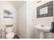 Cozy powder room with stylish mirror, pedestal sink, and tiled flooring at 4068 Sherri Ln, Fort Mill, SC 29715