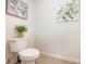 Cozy powder room featuring a decorative plant and framed floral artwork adding a touch of elegance at 4068 Sherri Ln, Fort Mill, SC 29715