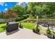 Backyard with deck, grill, and lush landscaping, perfect for outdoor enjoyment at 4313 Wynborough Ln, Charlotte, NC 28269