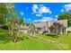 Picturesque backyard featuring a spacious deck, lush green lawn, and mature trees under a bright sky at 4313 Wynborough Ln, Charlotte, NC 28269
