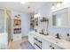 Bright bathroom with double sinks, a walk-in shower, and decorative storage shelves at 4313 Wynborough Ln, Charlotte, NC 28269